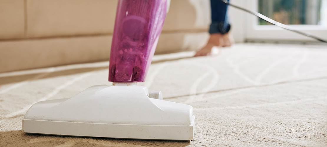 Blackwater Property Management Liberty Student vacuuming carpet in rented apartment lynchburg, va